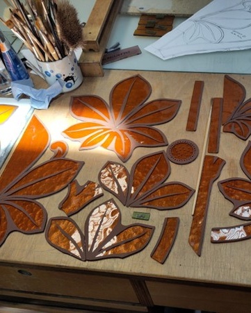 An image of assorted vine-style tracery pieces, pre-glazing